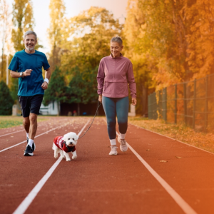 Dois tutores praticando esporte com cachorro